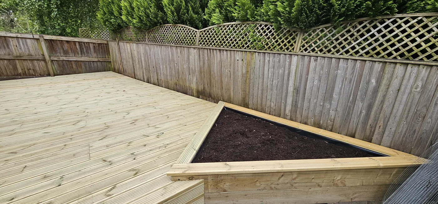 New timber decking with a raised planting bed after installation